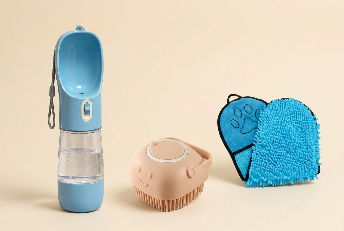“Oqelia GoCup dog water bottle, BathClean bath brush and blue DryCoat drying towel on a cream background